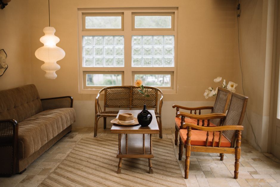 Ambiente de sala de estar com móveis de madeira, iluminação suave e decoração aconchegante, ideal para artigos sobre decoração de interiores ou momentos de descanso em casa.