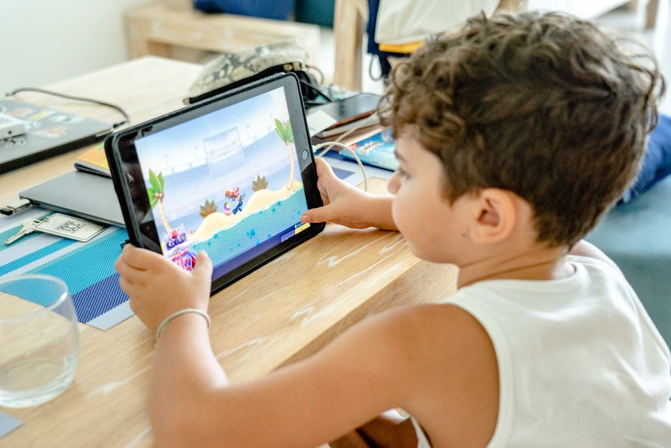 Criança jogando videogame em um ambiente doméstico, demonstrando o tema de entretenimento infantil e tecnologia.
