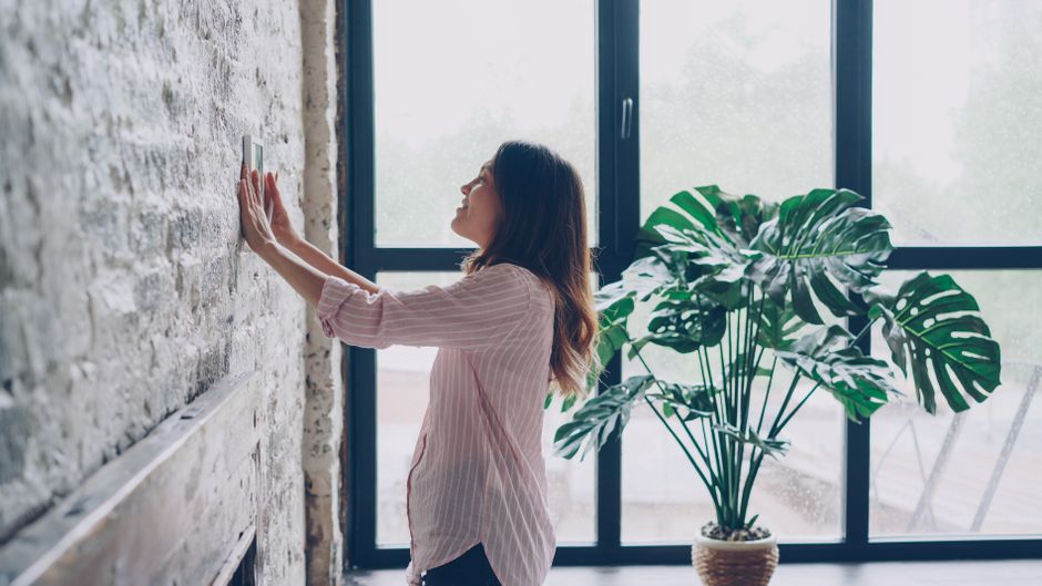 Mulher interagindo com um painel de controle no ambiente de trabalho para renovar ou ajustar configurações, simbolizando atualização ou gerenciamento de processos.