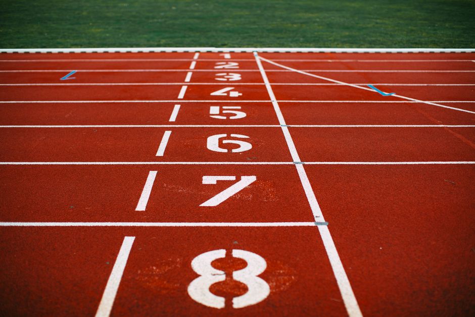 Pista de corrida de atletismo em foco, simbolizando velocidade, desempenho e competição.