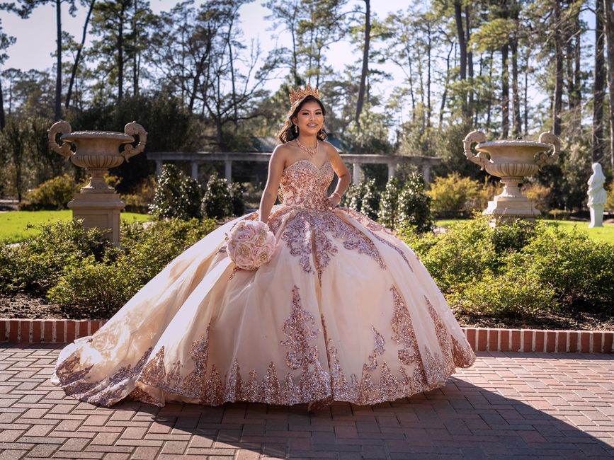 Jovem vestida com um vestido de casamento em um jardim ao ar livre, celebrando uma ocasião especial.