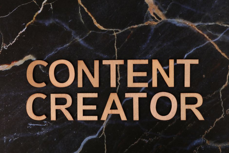 Imagem com o texto 'Content Creator' em destaque sobre fundo de mármore preto com veios dourados e brancos, simbolizando criatividade e produção de conteúdo digital.