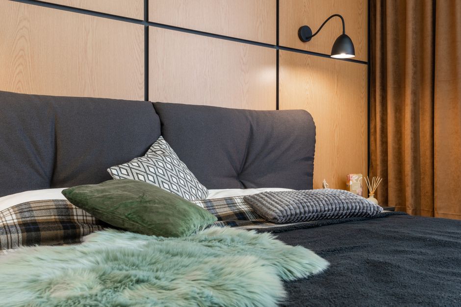 Cama estilo moderno e aconchegante em um quarto decorado com tons neutros e iluminação suave, criando um ambiente confortável e relaxante.