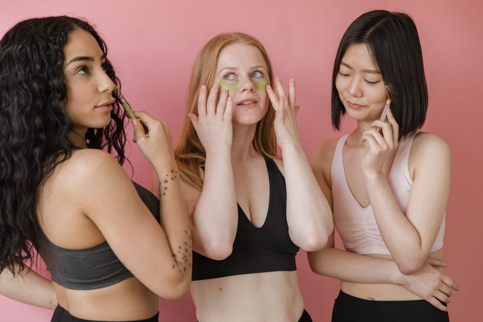 Três mulheres cuidando da rotina de beleza e autocuidado, demonstrando a importância de bem-estar e autoestima.