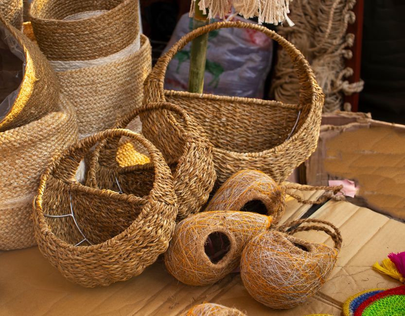 Imagem de cestas e objetos de artesanato feitos de fibras naturais, reforçando temas de artesanato e sustentabilidade.