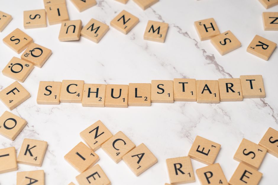 Imagem com peças de borracha com letras formando a palavra 'SCHOOL START', representando o início de um ano escolar.