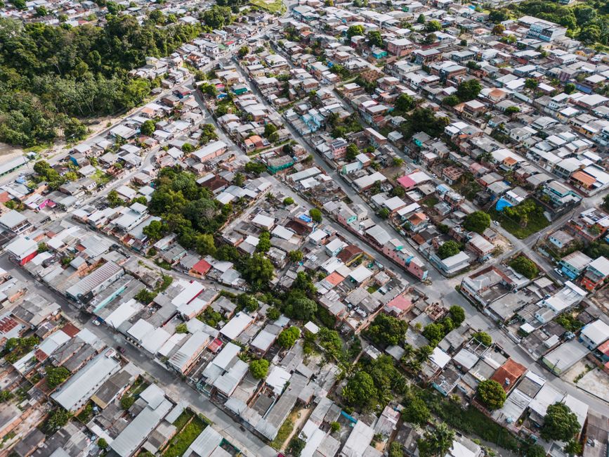 Imagem aérea de uma região urbana com casas organizadas em ruas, mostrando a estrutura de uma comunidade residencial.