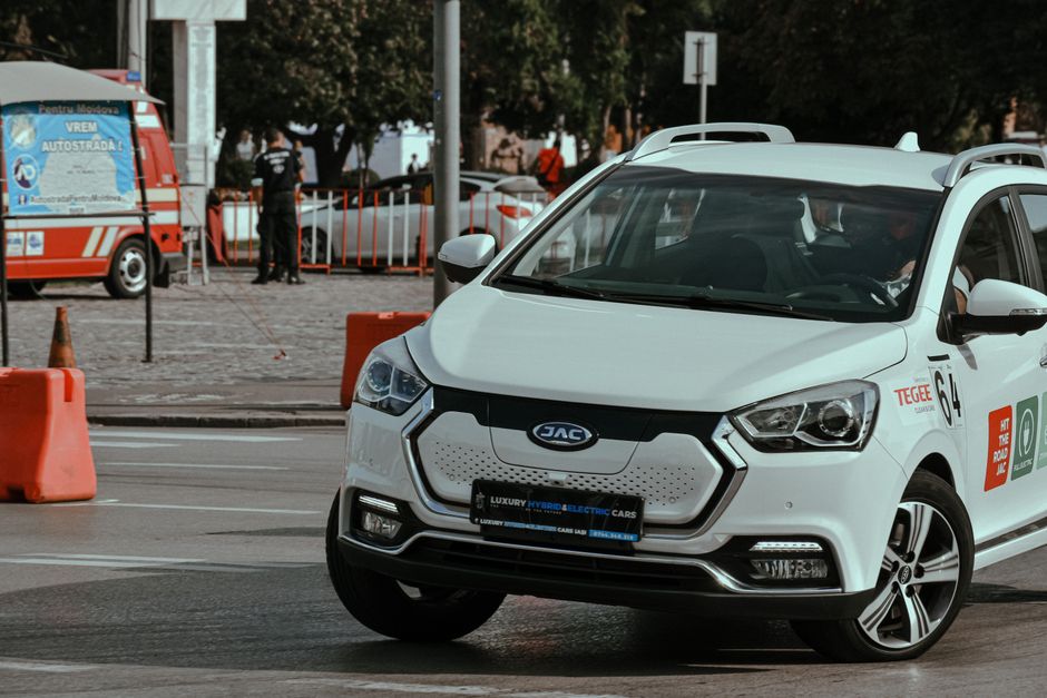 Foto de um carro elétrico em uma rua urbana, destacando a mobilidade sustentável e inovação no transporte.