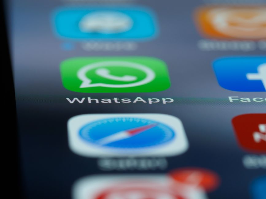 Imagem de um smartphone com foco na tela exibindo o aplicativo WhatsApp, representando comunicação digital e conectividade.