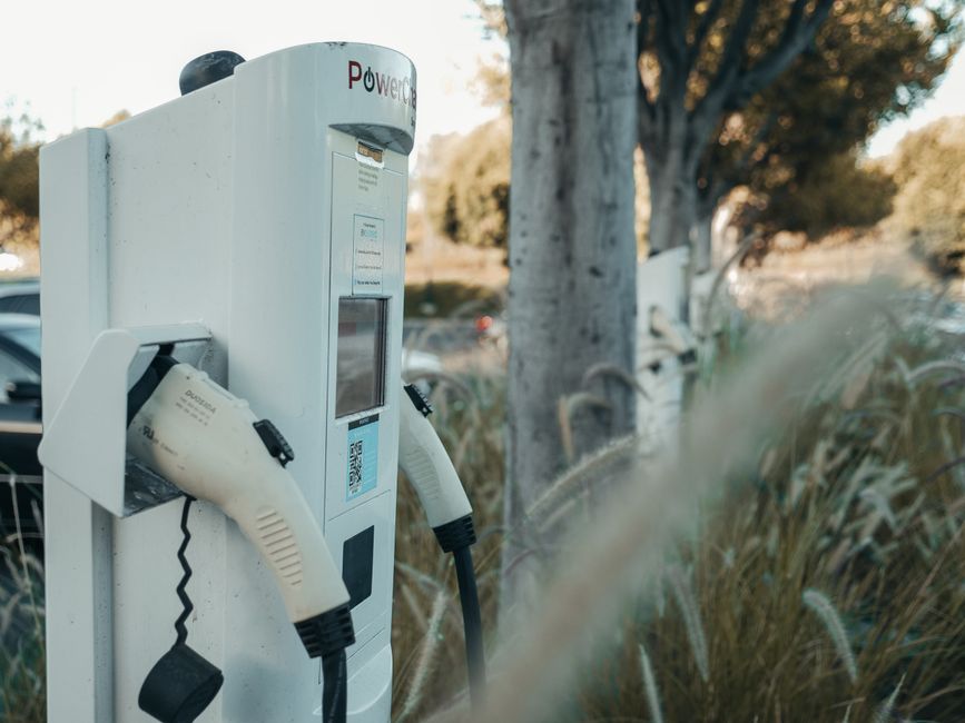 Estação de carregamento de veículos elétricos ao ar livre, destacando a sustentabilidade e inovação no transporte.
