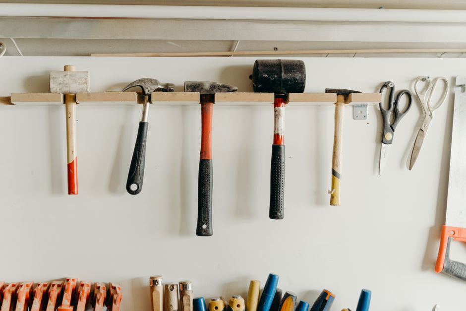 Ferramentas de marcenaria organizadas em uma parede de escritório, simbolizando manutenção, bricolagem ou projetos de construção.