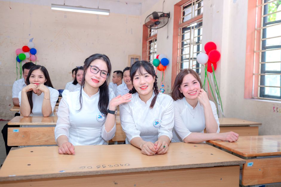 Grupo de estudantes sorridentes em sala de aula decorada para uma celebração escolar, promovendo integração e alegria no ambiente educacional.
