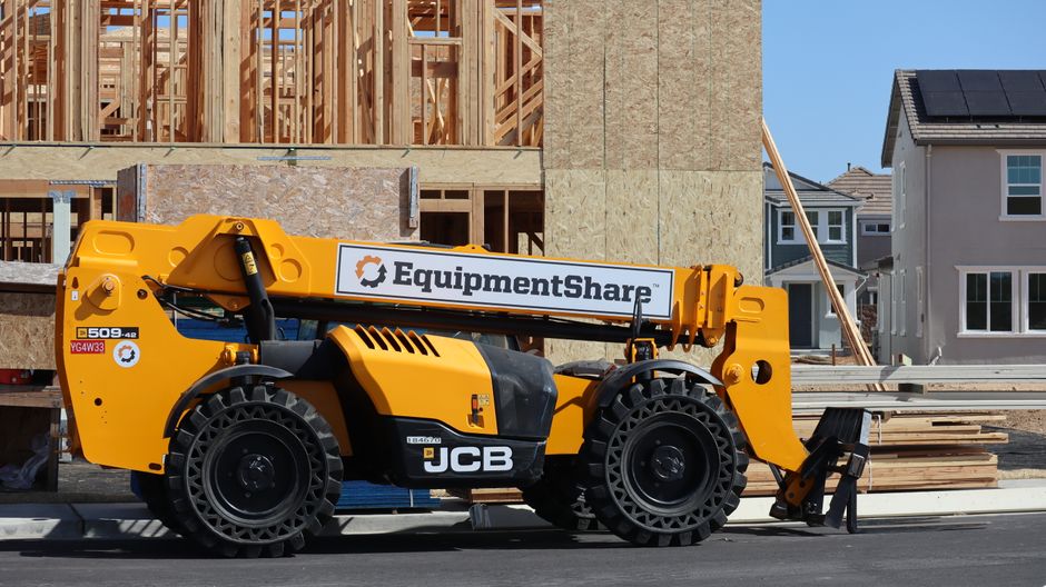 Máquina de construção utilizada em obras residenciais para transporte de materiais, representando o setor de construção civil em andamento.